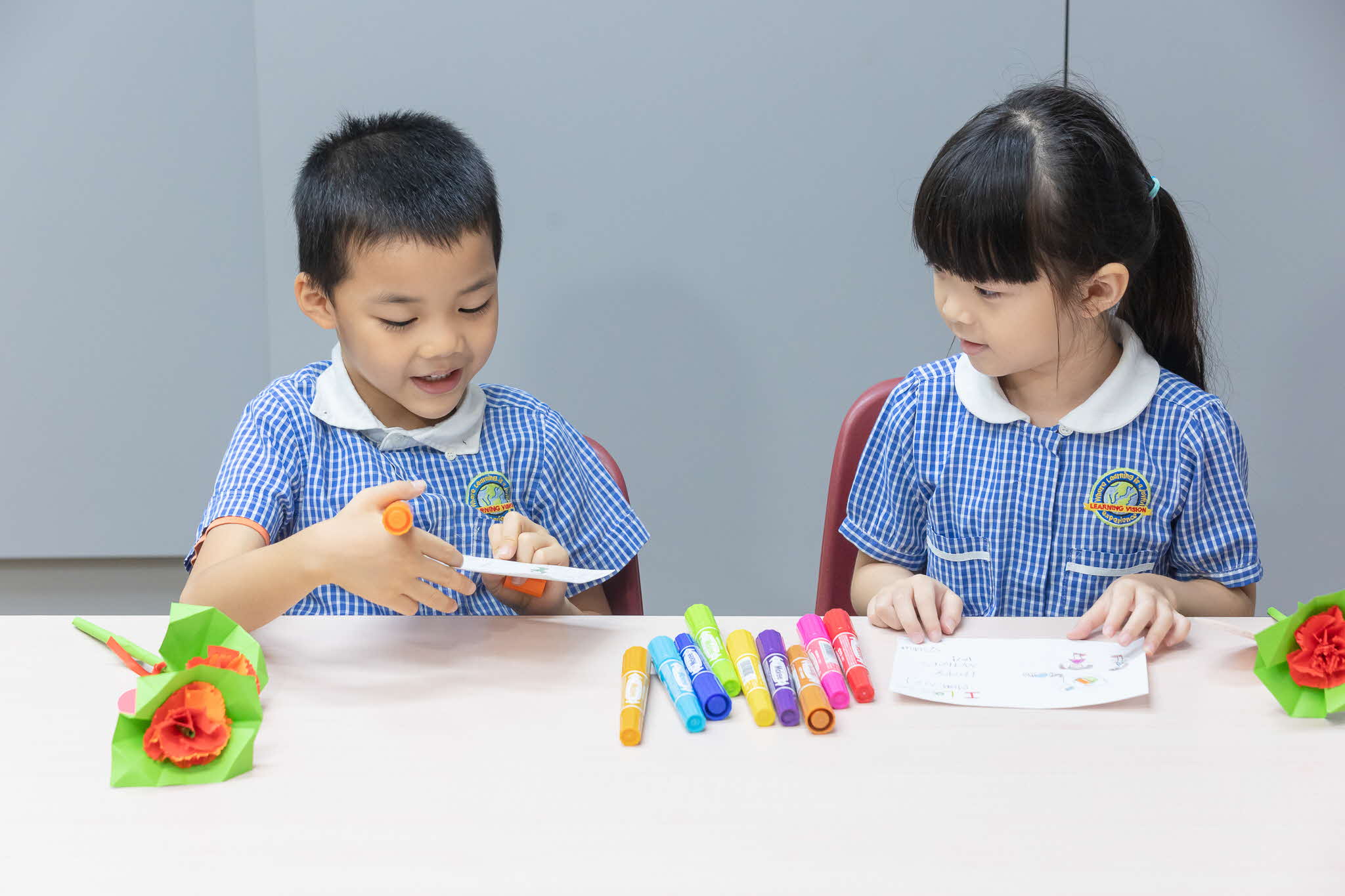 children writing cards with markers